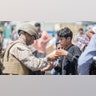 A Marine with Special Purpose Marine Air-Ground Task Force-Crisis Response-Central Command (SPMAGTF-CR-CC) provides sunscreen to a child during an evacuation at Hamid Karzai International Airport, Kabul, Afghanistan, Aug. 22. U.S. service members are assisting the Department of State with an orderly drawdown of designated personnel in Afghanistan. (U.S. Marine Corps photo by Sgt. Samuel Ruiz).