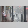 NEW ORLEANS, LOUISIANA - AUGUST 29: A woman walks her dog in the French Quarter during Hurricane Ida on August 29, 2021 in New Orleans, Louisiana. Ida made landfall earlier today southwest of New Orleans.  (Photo by Scott Olson/Getty Images)