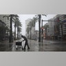 A pedestrian walks across Canal Street as Hurricane Ida makes landfall in New Orleans, Louisiana, U.S., on Sunday, Aug. 29, 2021. Hurricane Ida barreled into the Louisiana coast on Sunday, packing winds more powerful than Hurricane Katrina and a devastating storm surge that threatens to inundate New Orleans with mass flooding, power outages and destruction. Photographer: Luke Sharrett/Bloomberg via Getty Images