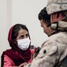 In this image provided by the U.S. Marine Corps, a Marine processes youth to be evacuated, at Hamid Karzai International Airport, Monday, Aug. 23. (Gunnery Sgt. Melissa Marnell/U.S. Marine Corps via AP)