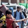 In this image provided by the U.S. Marine Corps, a Marine with Special Purpose Marine Air-Ground Task Force-Crisis Response-Central Command shares a fist-bump with a child during an evacuation at Hamid Karzai International Airport in Kabul, Afghanistan, Tuesday, Aug. 24, 2021. (Sgt. Samuel Ruiz/U.S. Marine Corps via AP)