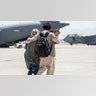 A family walks towards a U.S. Air Force Boeing C-17 Globemaster III during an evacuation at Hamid Karzai International Airport, Kabul, Afghanistan, Aug. 22. U.S. service members are assisting the Department of State with an orderly drawdown of designated personnel in Afghanistan. (U.S. Marine Corps photo by Sgt. Samuel Ruiz).