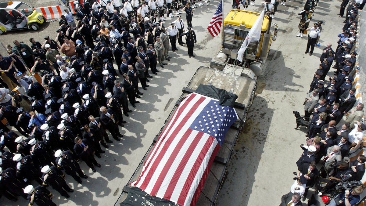 The last steel girder left standing at the World Trade Center, covered with black cloth and an American flag, is carried from the World Trade Center site in New York 