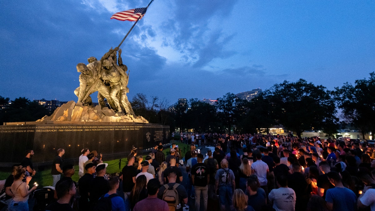 A large group of people gather at the United States Marine Corps War Memorial for a candlelight vigil in memory of the 11 Marines, one Navy Corpsman and one U.S. Army Soldier who lost their lives on August 26, 2021, during an attack in Kabul, Afghanistan, in Arlington, Virginia, U.S. August 28, 2021. Picture taken August 28, 2021. U.S. Marine Corps/Staff Sgt. Kelly L. Timney/Handout via REUTERS THIS IMAGE HAS BEEN SUPPLIED BY A THIRD PARTY.