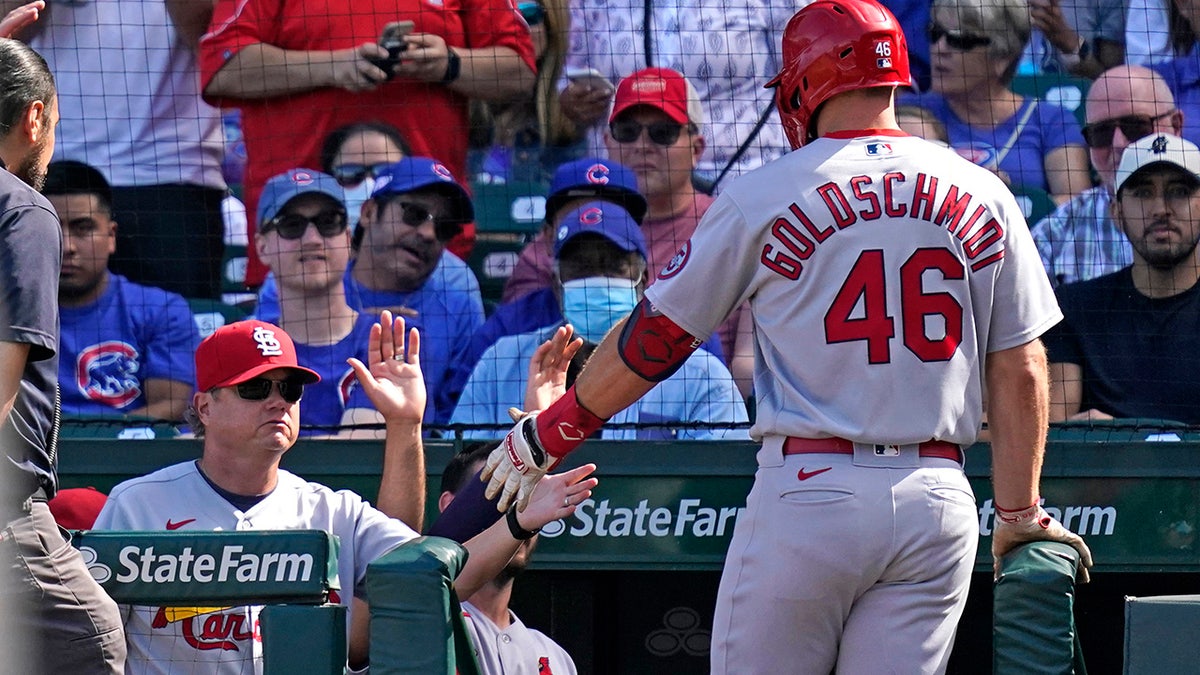 St. Louis Cardinals manager Mike Shildt, left, congratulates Paul Goldschmidt after Goldschmidt's solo home run during the third inning of a baseball game against the Chicago Cubs in Chicago, Sunday, Sept. 26, 2021. (AP Photo/Nam Y. Huh)