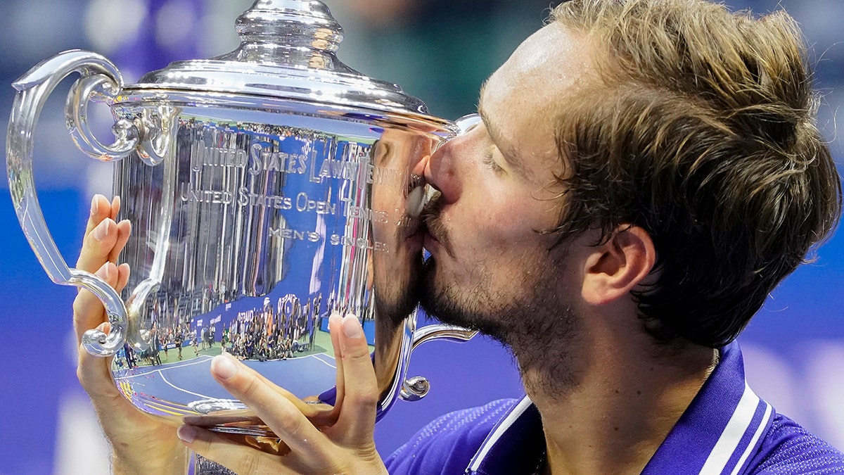 Daniil Medvedev, of Russia, kisses the championship trophy after defeating Novak Djokovic, of Serbia, in the men's singles final of the US Open tennis championships, Sunday, Sept. 12, 2021, in New York. (AP Photo/John Minchillo)