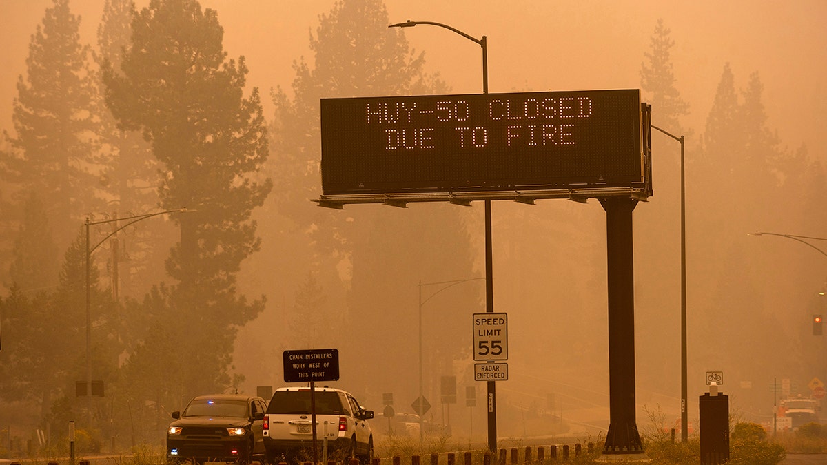 In this Aug. 27 photo, a sign in Eldorado County, Calif., warns motorists about the closure of Highway 50, which is shut down in both directions due to the Caldor Fire.