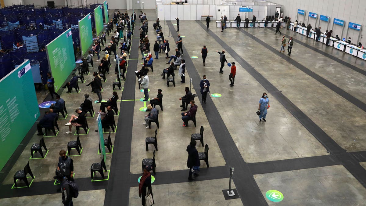 People wait to get vaccinated at the Vaccination Centre of Hope at the Cape Town International Convention Centre in Cape Town, South Africa, Tuesday Aug. 24, 2021. South Africa's Health Minister Joe Phaahla says on Friday, Sept. 3, 2021 the government will let businesses decide whether or not to make vaccinations mandatory for employees and clients. He said restaurants, bars, grocery stores and other businesses must set their own policies on whether or not to insist that patrons must be vaccinated. (AP Photo/Nardus Engelbrecht)