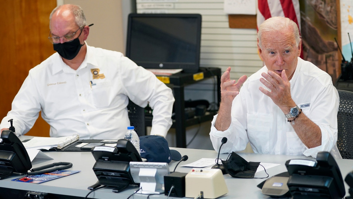 President Joe Biden participates in a briefing about the response to damage caused by Hurricane Ida, at the St. John Parish Emergency Operations Center, Friday, Sept. 3, 2021, in LaPlace, La., as Louisiana Gov. John Bel Edwards listens. (AP Photo/Evan Vucci)