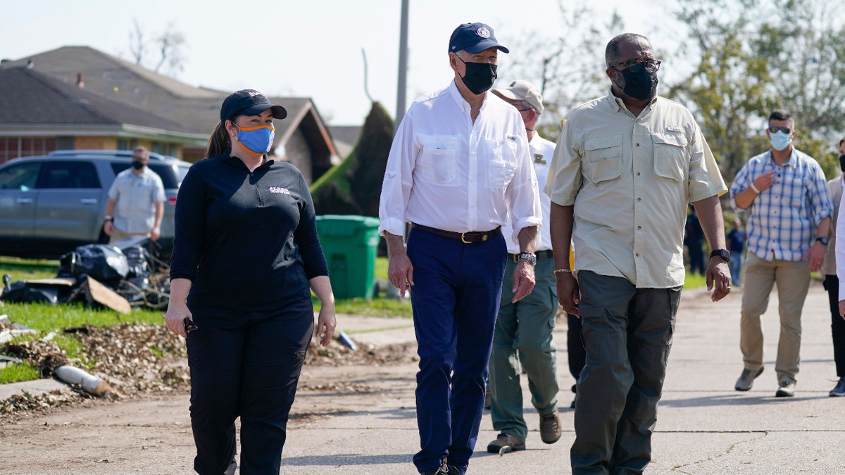 President Joe Biden tours a neighborhood impacted by Hurricane Ida, Friday, Sept. 3, 2021, in LaPlace, La. (AP Photo/Evan Vucci)