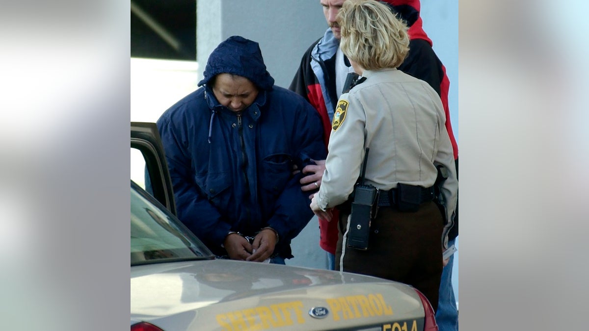 In this Dec. 3, 2003 file photo, Alfonso Rodriguez Jr., left, is helped into a sheriff's car after waiving extradition at the Polk County Courthouse in Crookston, Minnesota.