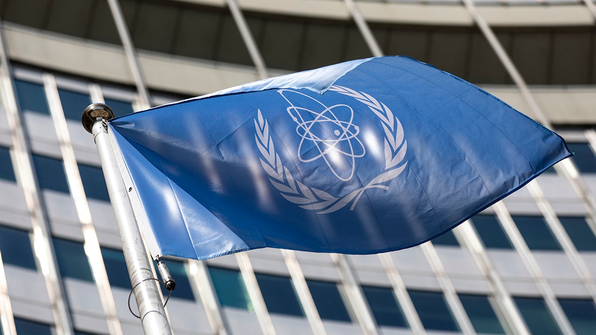 In this Monday, June 7, 2021 file photo, the flag of the International Atomic Energy Agency (IAEA) waves at the entrance of the Vienna International Center in Vienna.