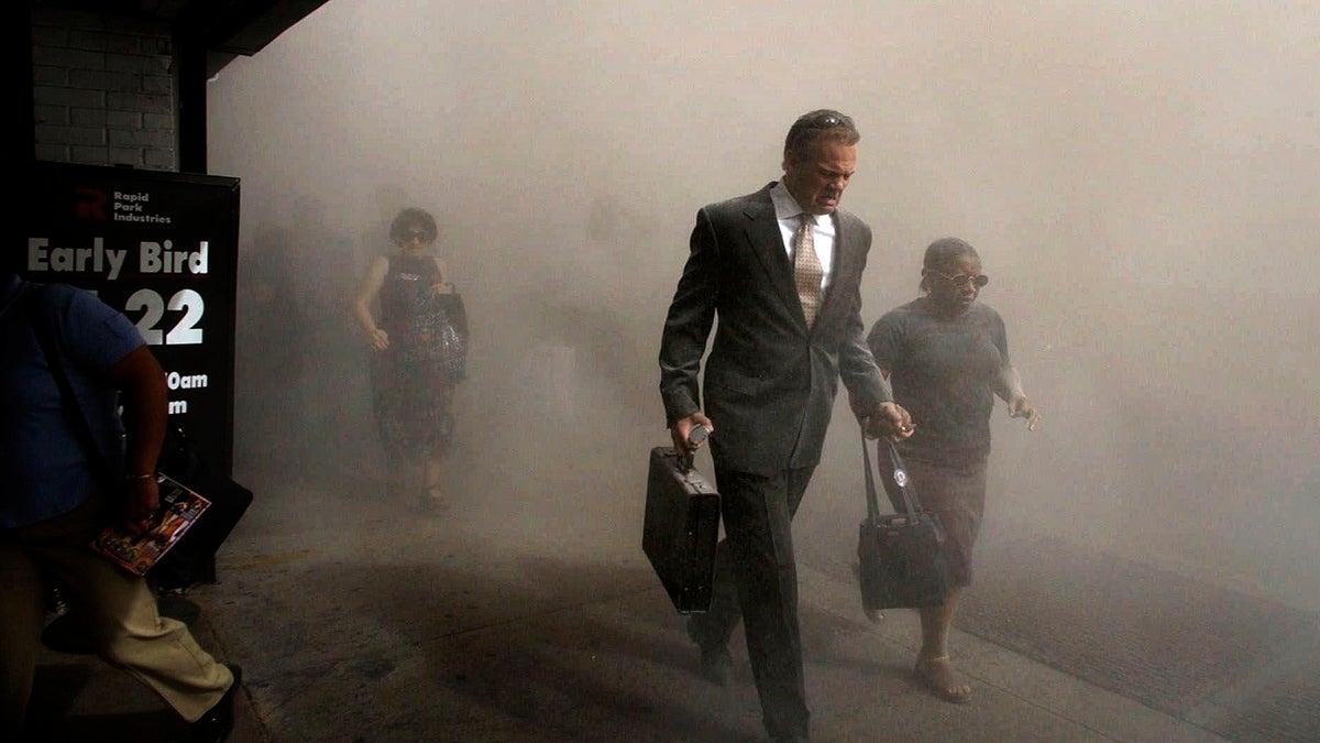 Pedestrians flee the area of New York's World Trade Center in lower Manhattan on Tuesday, Sept. 11, 2001. (AP Photo/Amy Sancetta)