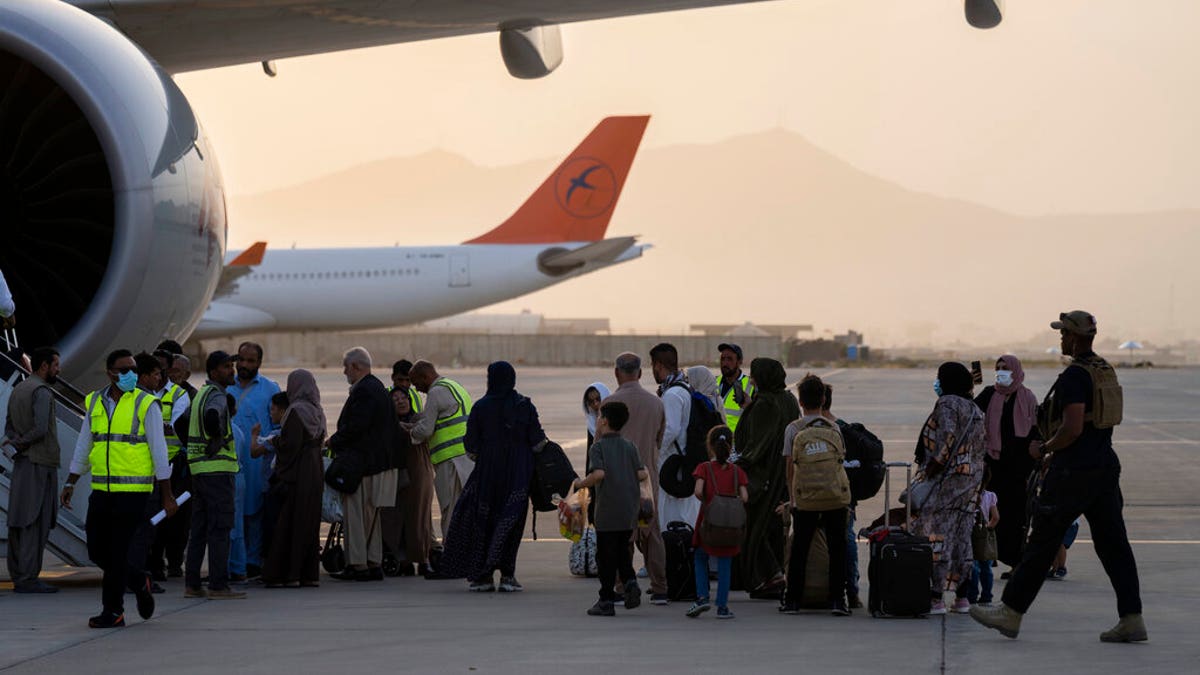 Passengers board Qatar Airways aircraft