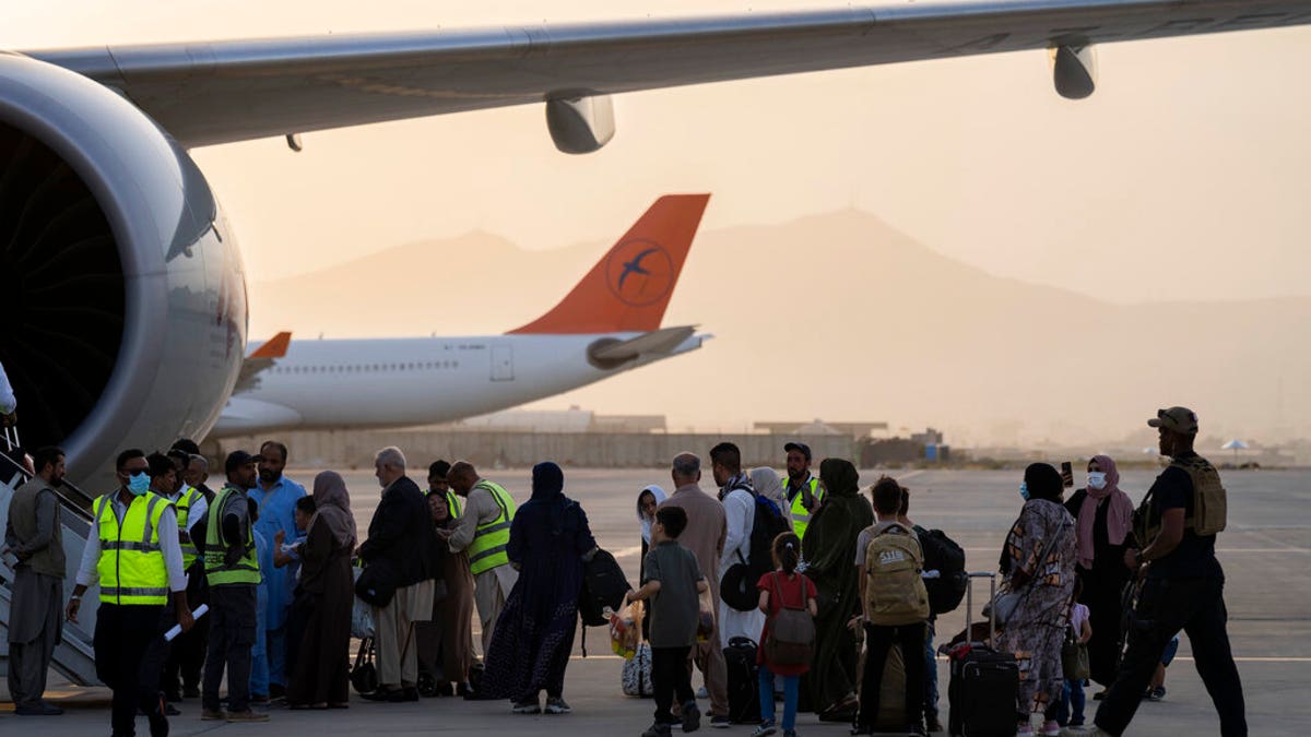 Passengers board Qatar Airways aircraft