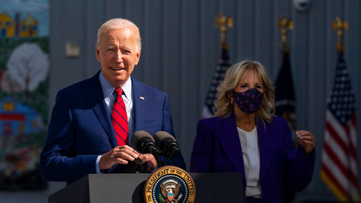 President Biden at podium with Jill Biden to his left
