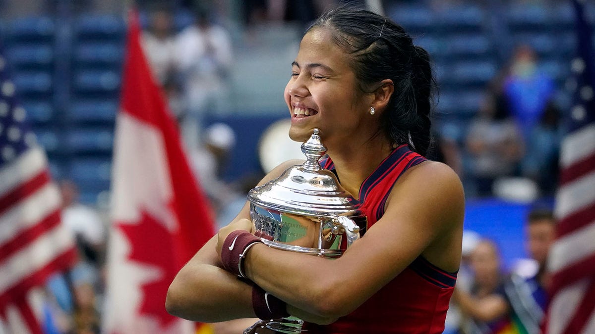 Emma Raducanu hugs trophy