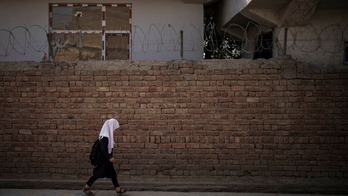 A girl walks to school before class in Kabul, Afghanistan, Sunday, Sept. 12, 2021.