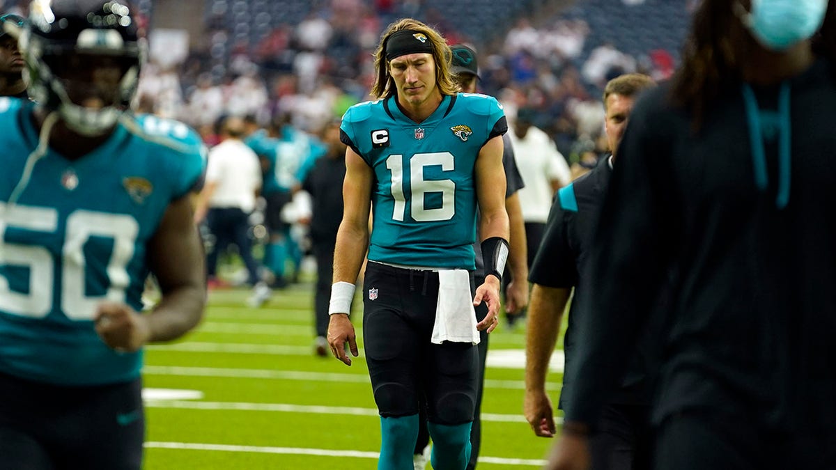 Jacksonville Jaguars quarterback Trevor Lawrence (16) walks off the field after an NFL football game against the Houston Texans Sunday, Sept. 12, 2021, in Houston. The Texans won 37-21. (AP Photo/Sam Craft)