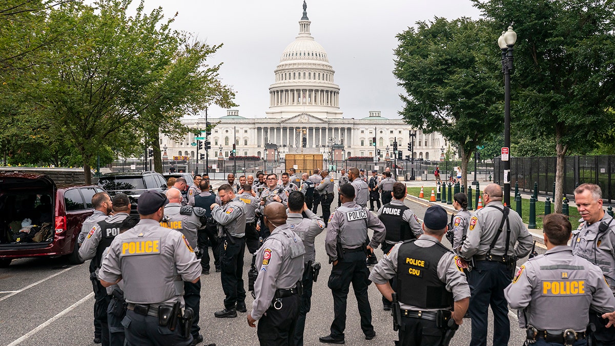 Police stage at a security fence ahead of a rally near the U.S. Capitol in Washington