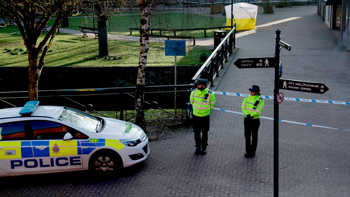 FILE - In this Wednesday, March 7, 2018 file photo, police officers guard a cordon around a police tent covering the the spot where former Russian double agent Sergei Skripal and his daughter were found critically ill.