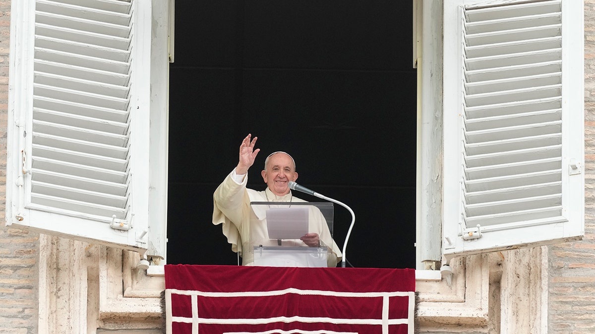 Pope Francis waves to faithful during the Angelus noon prayer in St. Peter's Square at the Vatican, Sunday, Sept 26, 2021. (AP Photo/Andrew Medichini)