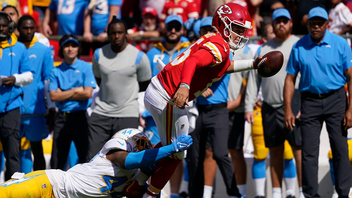 Kansas City Chiefs quarterback Patrick Mahomes (15) is tackled by Los Angeles Chargers' Kyzir White (44) during the first half of an NFL football game, Sunday, Sept. 26, 2021, in Kansas City, Mo.