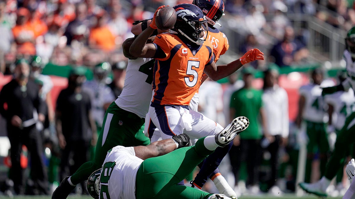 New York Jets defensive tackle Sheldon Rankins tackles Denver Broncos quarterback Teddy Bridgewater (5) during the first half of an NFL football game Sunday, Sept. 26, 2021, in Denver. (AP Photo/Jack Dempsey)