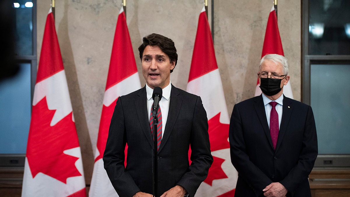 In this Sept. 24, 2021, file photo, Prime Minister Justin Trudeau stands with Minister of Foreign Affairs Marc Garneau to announce that Canadians Michael Spavor and Michael Kovrig have been released from detention in China, on Parliament Hill in Ottawa. China's Foreign Ministry said Monday, Sept. 27, 2021, that the two Canadians were released on bail for health reasons.