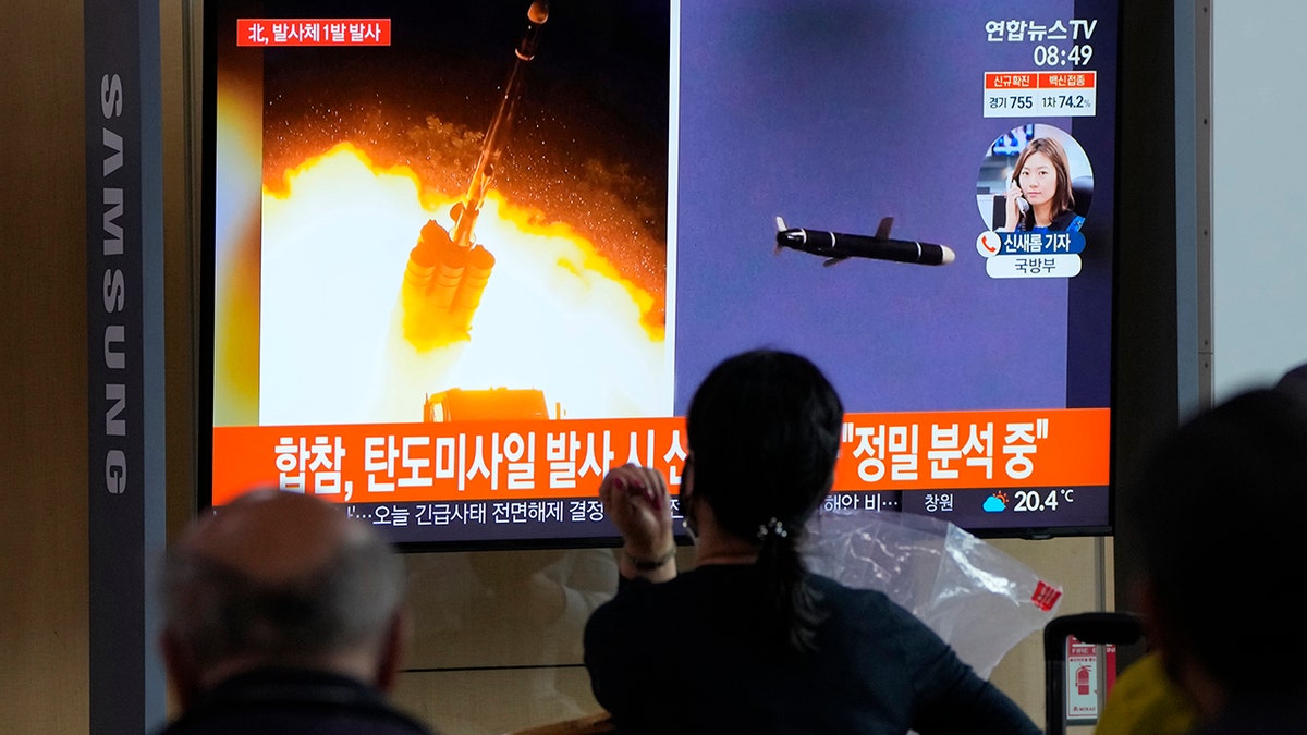 People watch a TV showing a file image of North Korea's missiles launch during a news program at the Seoul Railway Station in Seoul, South Korea, Tuesday, Sept. 28, 2021. (AP Photo/Ahn Young-joon)