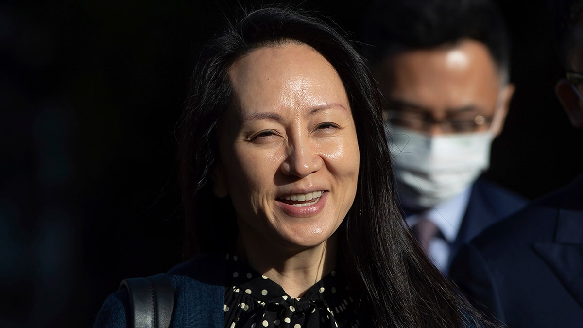 In this Sept. 24, 2021, file photo, Meng Wanzhou, chief financial officer of Huawei, smiles as she leaves her home in Vancouver. A pair of American siblings, Cynthia and Victor Liu, have returned to the U.S. on Sunday, Sept. 26, 2021, after China lifted an exit ban following Canada’s release of Meng wanted in the U.S. on fraud charges. 