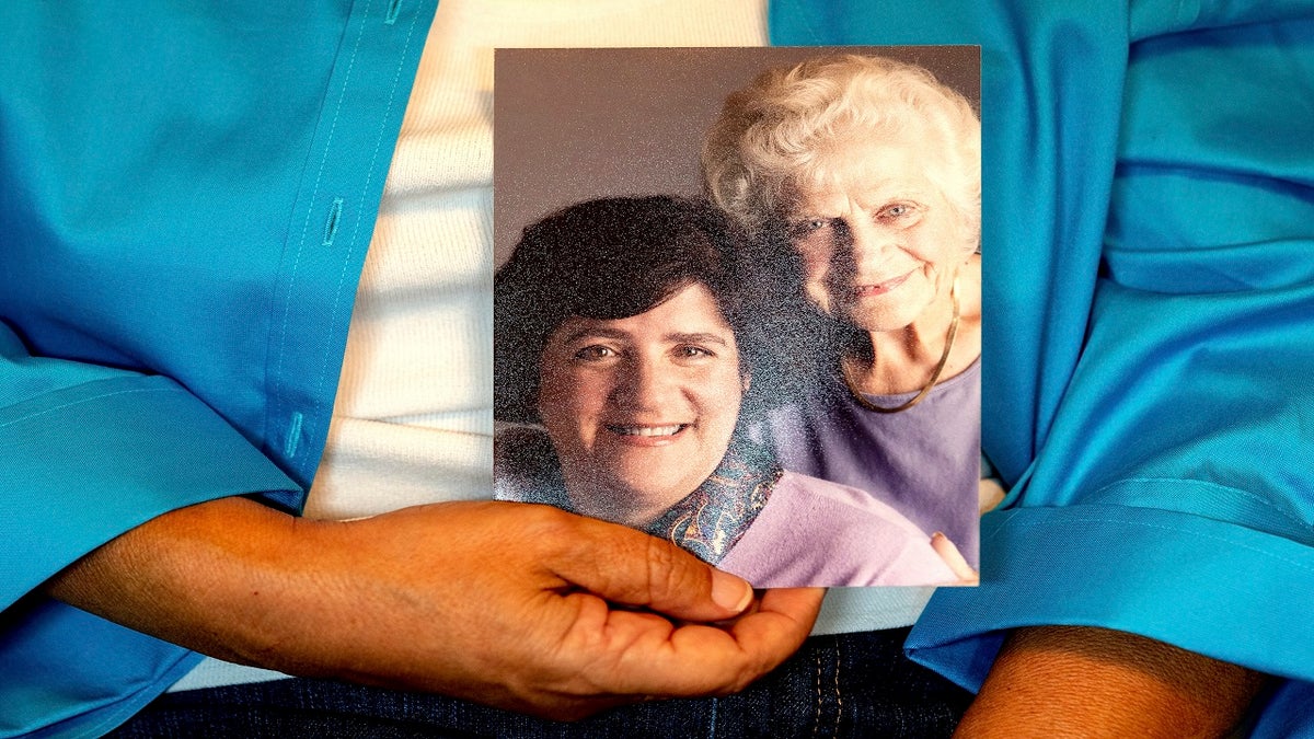 Sept 27, 2021: Dorene Giacopini holds a photo of her with her mother, Primetta Giacopini, from her home in Richmond, Calif. 
