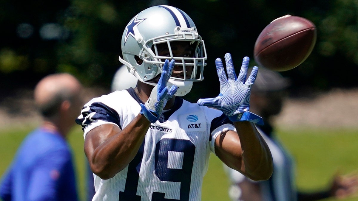 Dallas Cowboys wide receiver Amari Cooper reaches out to catch a pass during a workout at the team's NFL football training facility in Frisco, Texas, Wednesday, Aug. 25, 2021. (AP Photo/Tony Gutierrez)