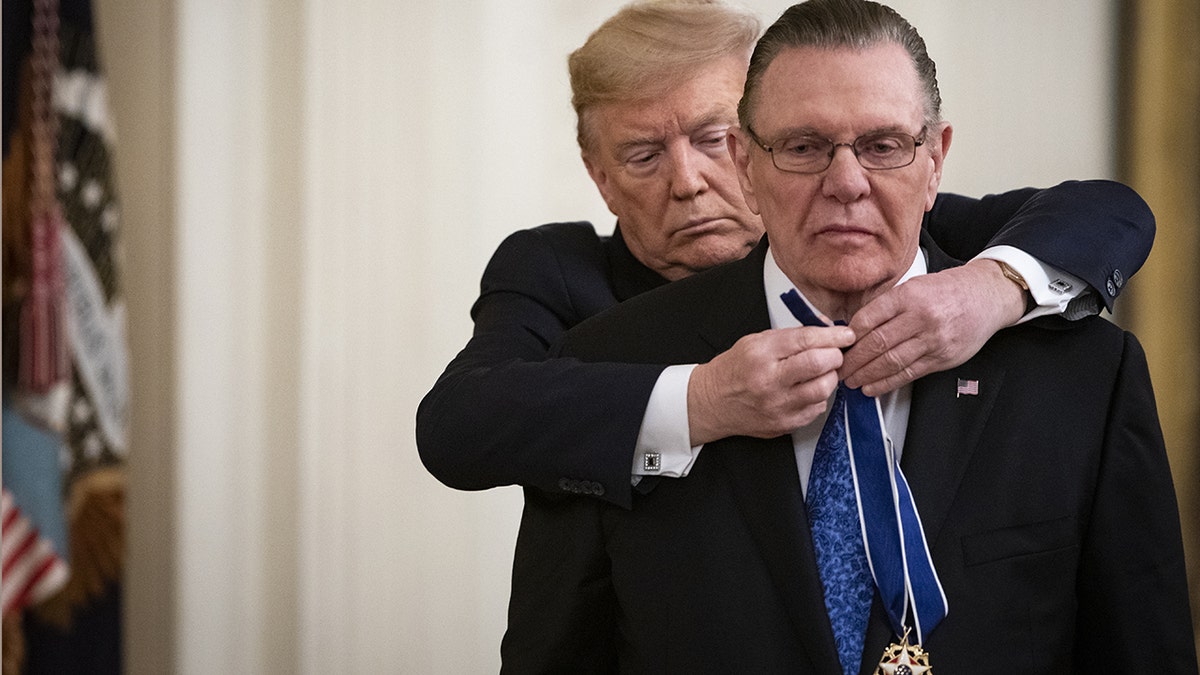 U.S. President Donald Trump presents the Presidential Medal of Freedom to retired General Jack Keane, chairman of AM General Holdings LLC, right, in the East Room of the White House in Washington, D.C., U.S., on Tuesday, March 10, 2020. Photographer: AL Drago/Bloomberg via Getty Images