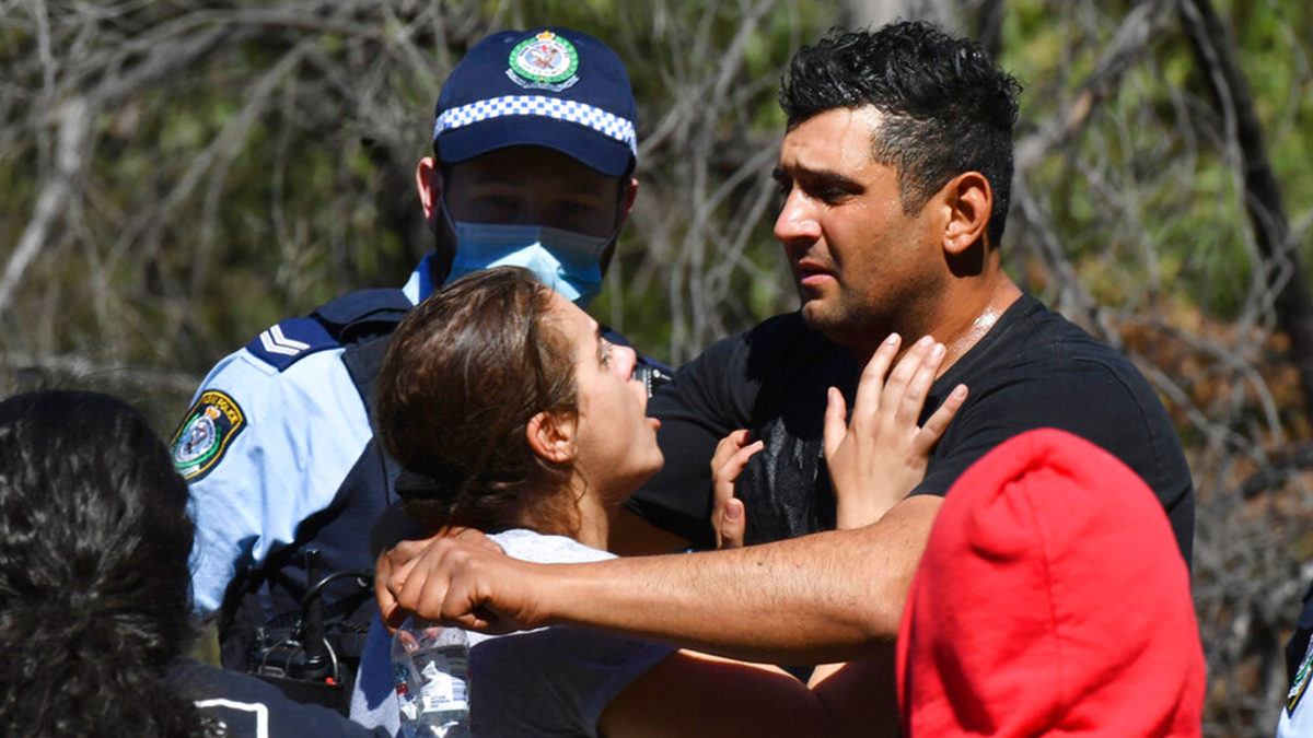 Anthony Elfalak, right, and his wife, Kelly, embrace after hearing their son AJ is found alive on the family property near Putty, north west of Sydney, Australia, Monday, Sept. 6, 2021.
