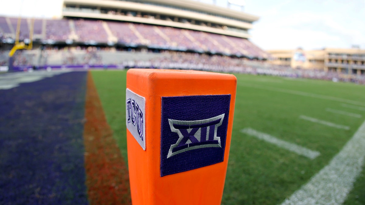 A Big 12 Conference logo is displayed on a goal line pylon before Duquesne played TCU in an NCAA college football game, in Fort Worth, Texas. The Big 12 has extended membership invitations to BYU, UCF, Cincinnati and Houston to join the Power Five league. That comes in advance of the league losing Oklahoma and Texas to the Southeastern Conference.