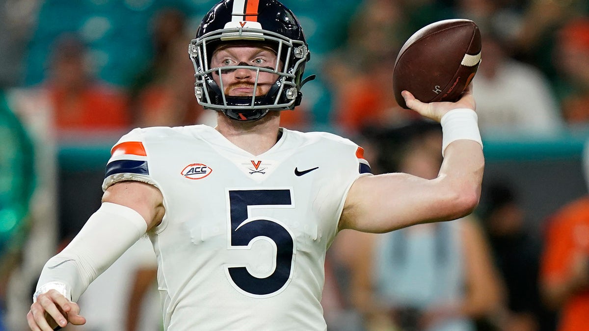 Virginia Cavaliers quarterback Brennan Armstrong (5) aims a pass during the first half of a NCAA college football game against the Miami Hurricanes, Thursday, Sept. 30, 2021, in Miami Gardens, Fla.