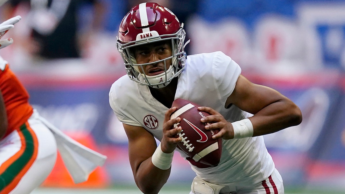 Alabama quarterback Bryce Young (9) scrambles away from Miami safety Gilbert Frierson (3) before throwing a touchdown pass during the first half of an NCAA college football game Saturday, Sept. 4, 2021, in Atlanta.