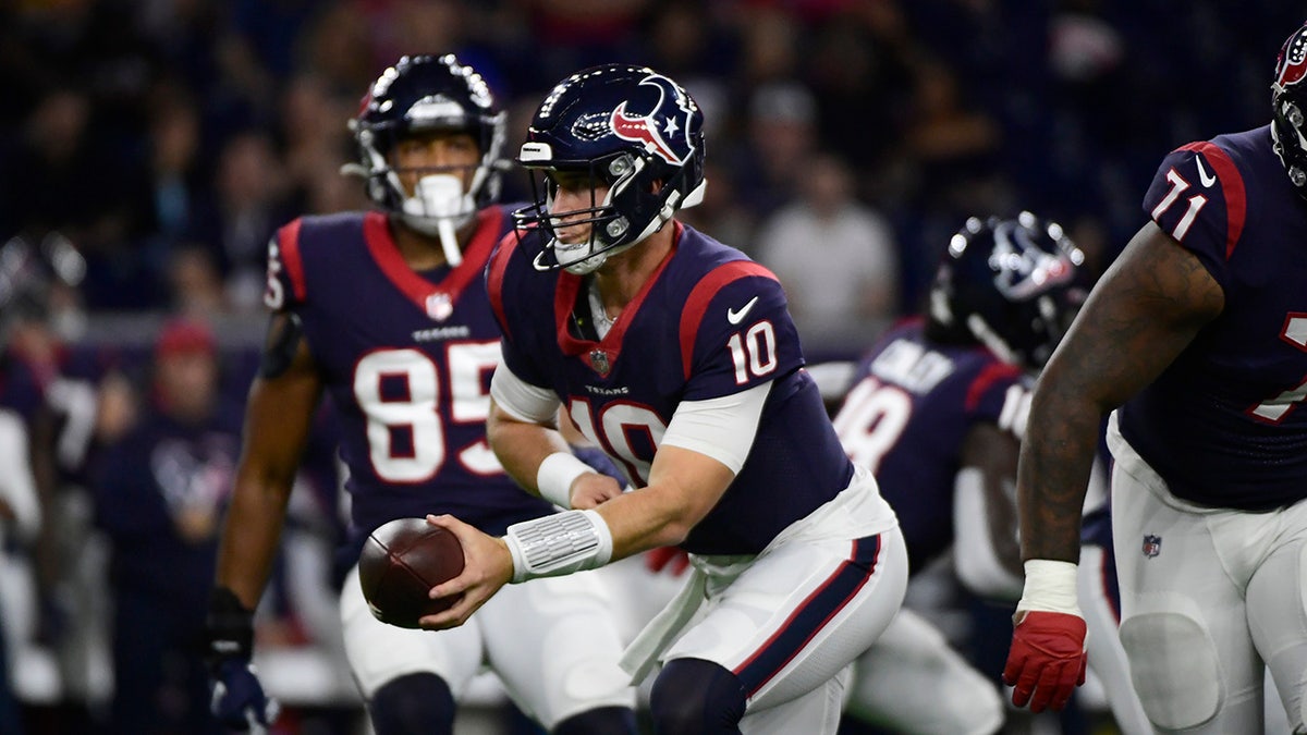 Houston Texans quarterback Davis Mills (10) looks to hand the ball off during the first half of an NFL football game against the Carolina Panthers Thursday, Sept. 23, 2021, in Houston.