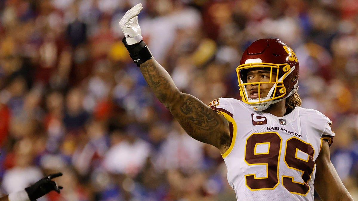 Washington Football Team defensive end Chase Young (99) gestures to fans against the New York Giants in the fourth quarter at FedExField.