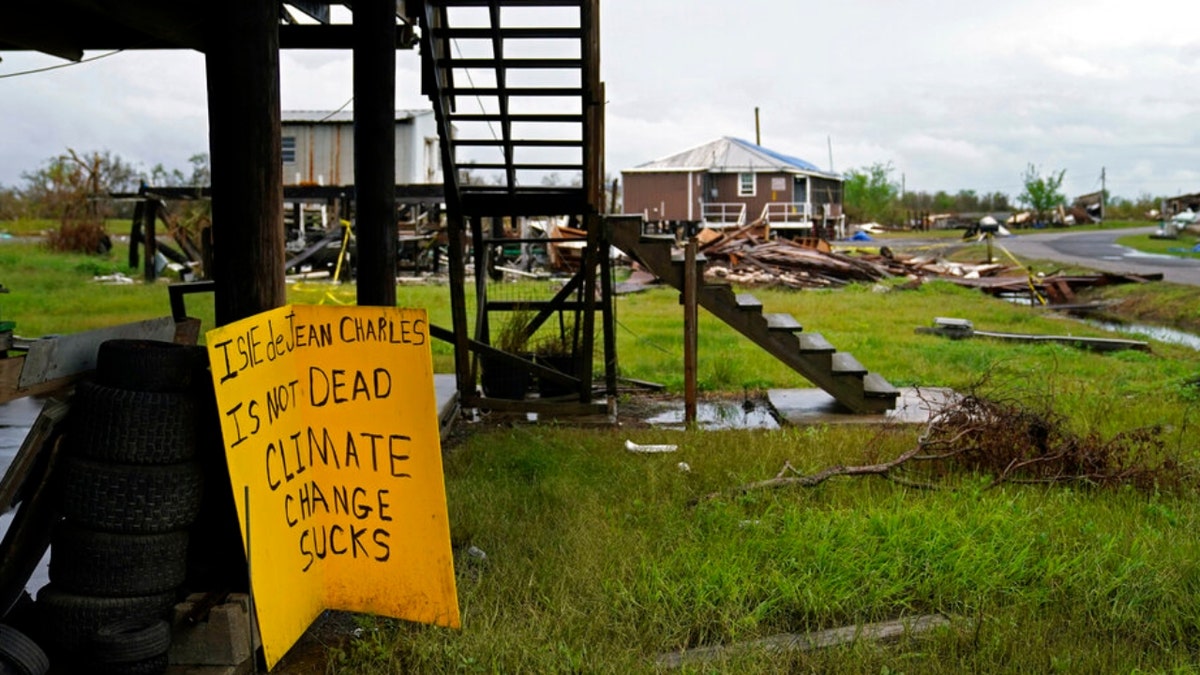 Storm clouds from Tropical Storm Nicholas are seen behind homes of the vanishing Native American community of Isle de Jean Charles, La., which were destroyed by Hurricane Ida, Tuesday, Sept. 14, 2021