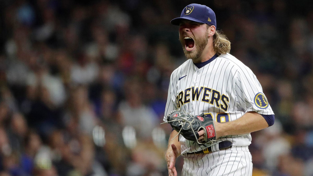 Milwaukee Brewers' Corbin Burnes reacts after striking out a batter during the seventh inning of a baseball game against the New York Mets Saturday, Sept. 25, 2021, in Milwaukee.