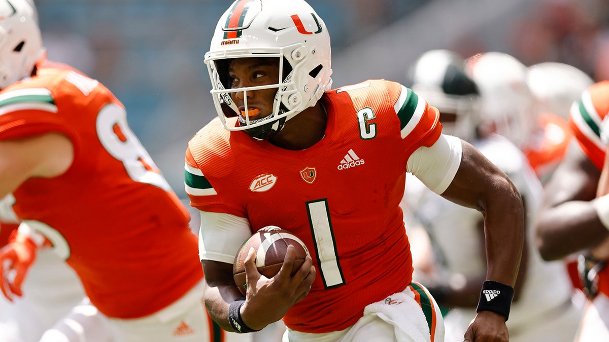 Miami quarterback D'Eriq King (1) runs with the ball during the first quarter of an NCAA college football game against Michigan State, Saturday, Sept. 18, 2021, in Miami Gardens, Fla. 
