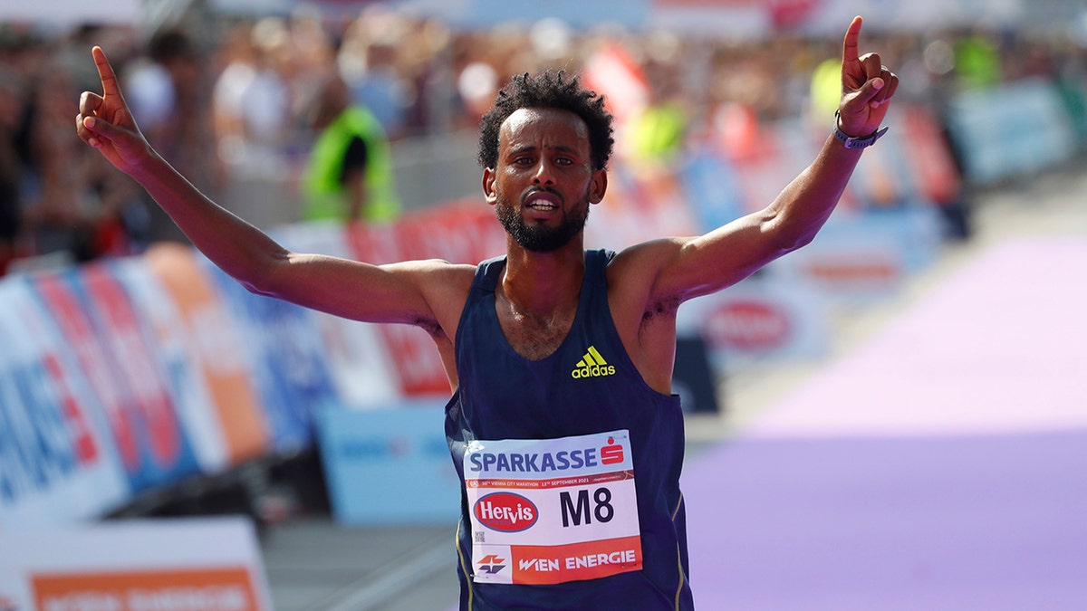 Ethiopia's Derara Hurisa celebrates after thinking he had won the race.