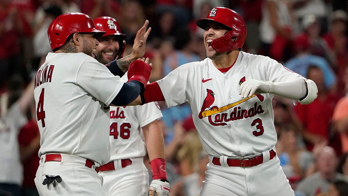 St. Louis Cardinals' Dylan Carlson (3) is congratulated by teammates Yadier Molina (4) and Paul Goldschmidt after hitting a grand slam during the eighth inning of a baseball against the San Diego Padres game Friday, Sept. 17, 2021, in St. Louis.