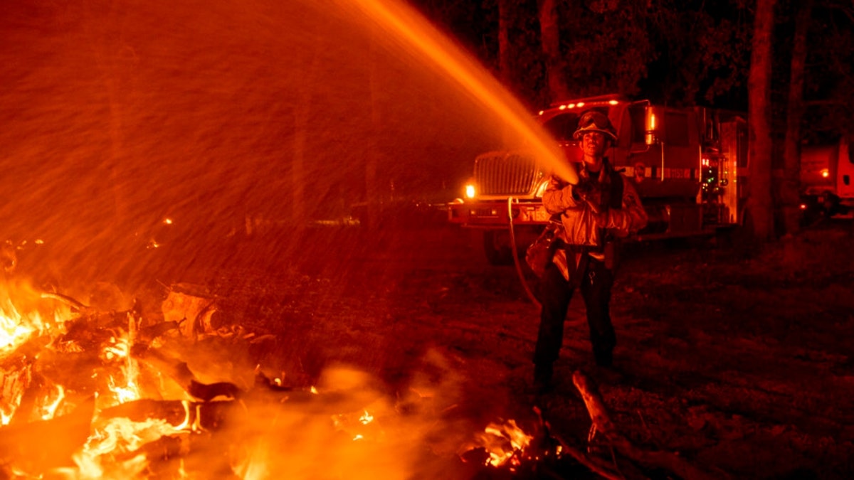 Firefighter Ron Burias battles the Fawn Fire as it spreads north of Redding, Calif. in Shasta County, on Thursday, Sept. 23, 2021.