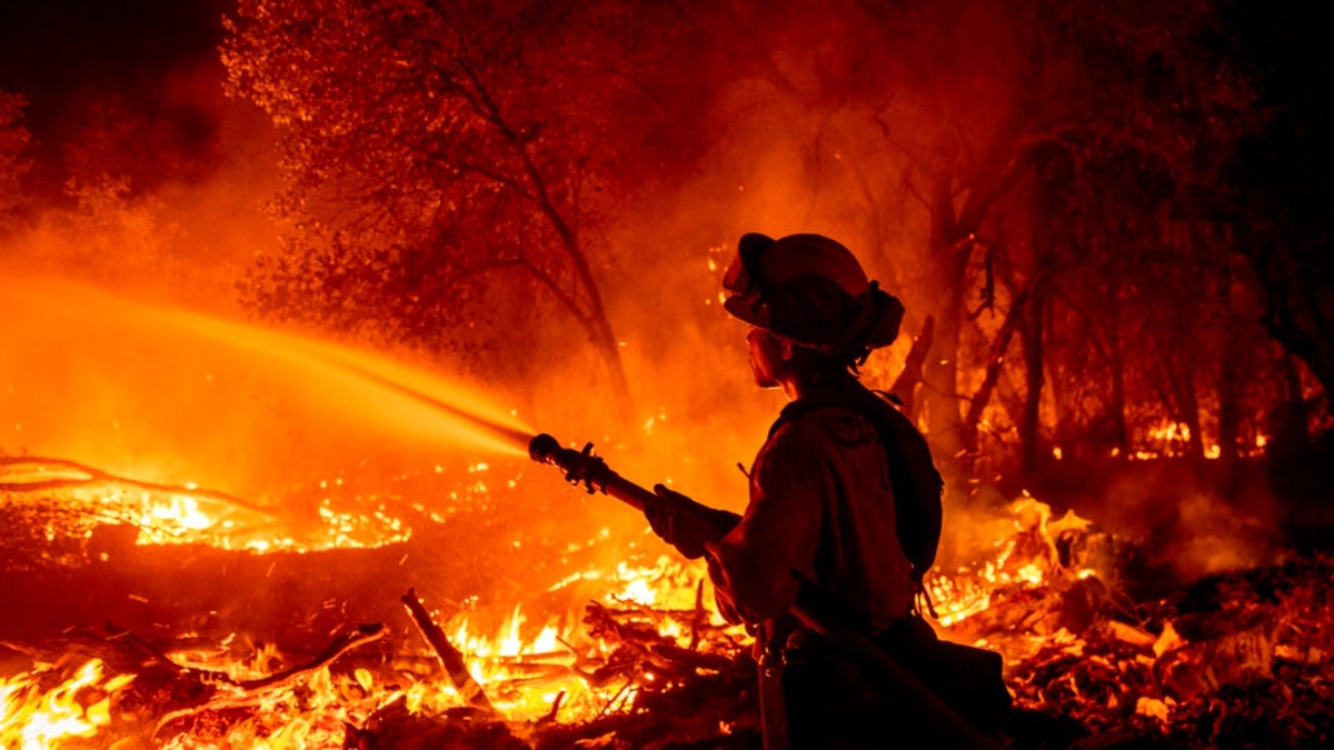 Firefighter Ron Burias battles the Fawn Fire as it spreads north of Redding, Calif. in Shasta County, on Thursday, Sept. 23, 2021.