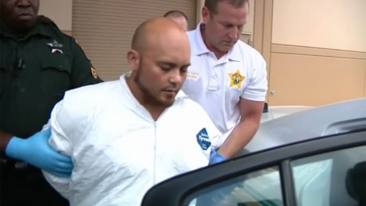 Bryan Riley, 33, of Brandon, Fla., is escorted from the Polk County Sheriff’s Operations Center to Polk County Jail Sunday afternoon.