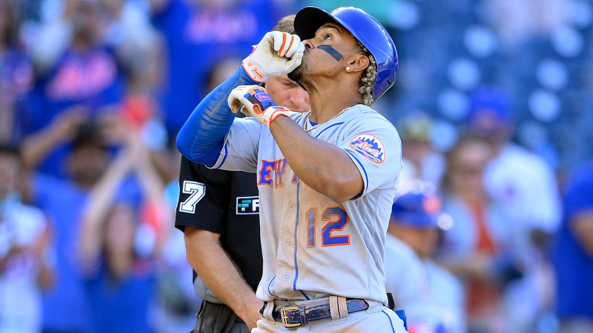 New York Mets' Francisco Lindor (12) celebrates his two-run home run during the ninth inning of the first baseball game of a doubleheader against the Washington Nationals, Saturday, Sept. 4, 2021, in Washington. The Mets won 11-9 in extra innings. (AP Photo/Nick Wass)
