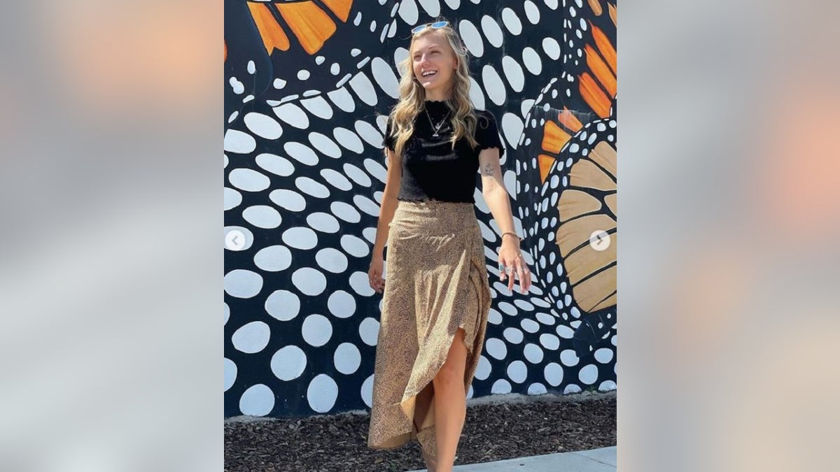 Gabby Petito pictured against a colorful wall